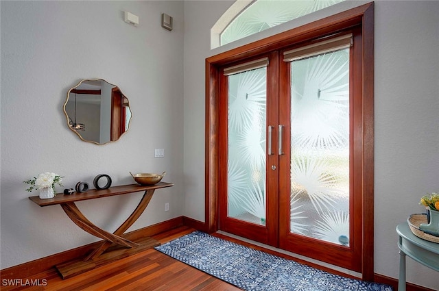 foyer entrance with dark wood-type flooring and french doors