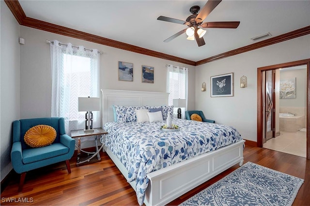 bedroom featuring hardwood / wood-style floors, ensuite bath, ceiling fan, and multiple windows