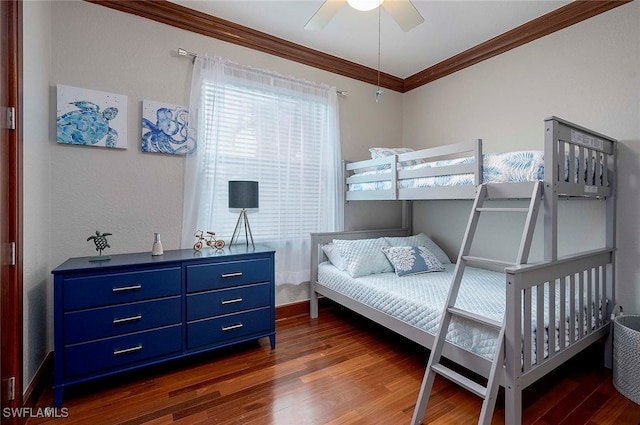 bedroom featuring dark hardwood / wood-style flooring, ceiling fan, and crown molding