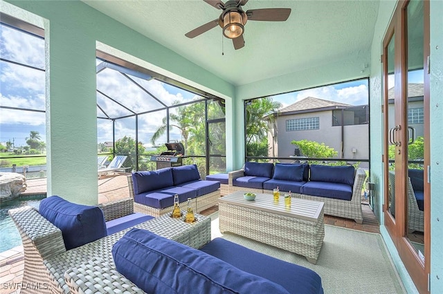 sunroom / solarium featuring ceiling fan