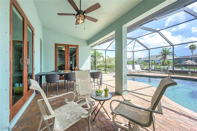 exterior space with a lanai, a patio area, ceiling fan, and french doors