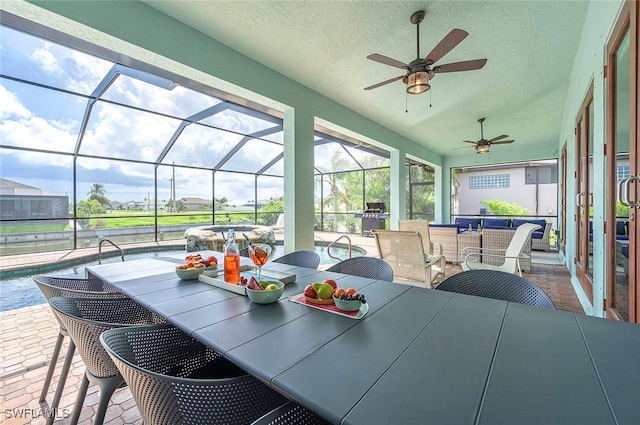 sunroom / solarium featuring ceiling fan