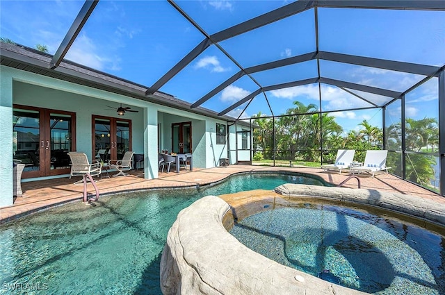 view of swimming pool with an in ground hot tub, french doors, ceiling fan, and a patio area