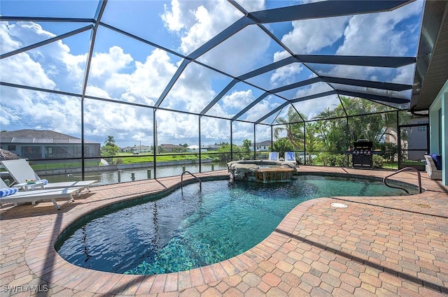 view of pool featuring an in ground hot tub, a patio, a water view, and glass enclosure