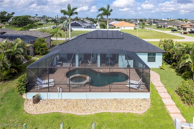 view of swimming pool with glass enclosure, an in ground hot tub, and a patio