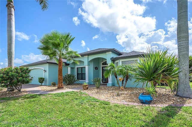 view of front of house with a garage and a front yard