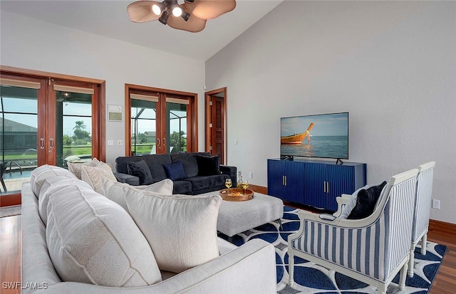 living room with french doors, vaulted ceiling, ceiling fan, and dark wood-type flooring