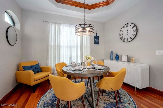 dining room with a chandelier, ornamental molding, plenty of natural light, and dark wood-type flooring