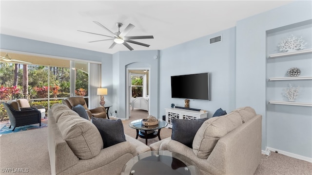 living room with ceiling fan and light colored carpet