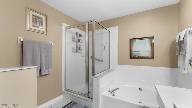 bathroom featuring shower with separate bathtub