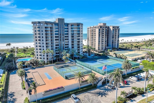 birds eye view of property with a water view and a view of the beach