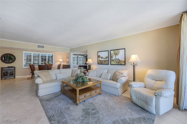 living room featuring ornamental molding and light tile patterned floors