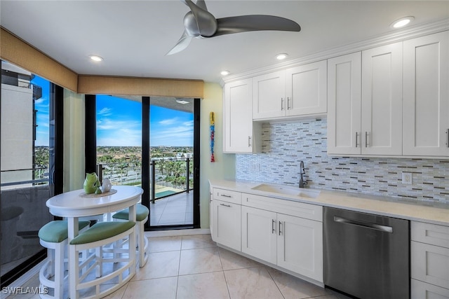 kitchen with dishwasher, decorative backsplash, white cabinets, and sink