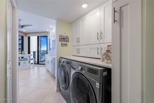 clothes washing area with cabinets, light tile patterned floors, washer and dryer, and ceiling fan