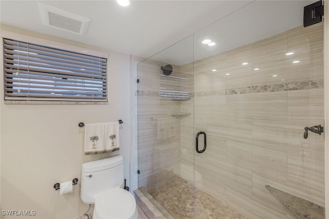 bathroom featuring toilet and an enclosed shower