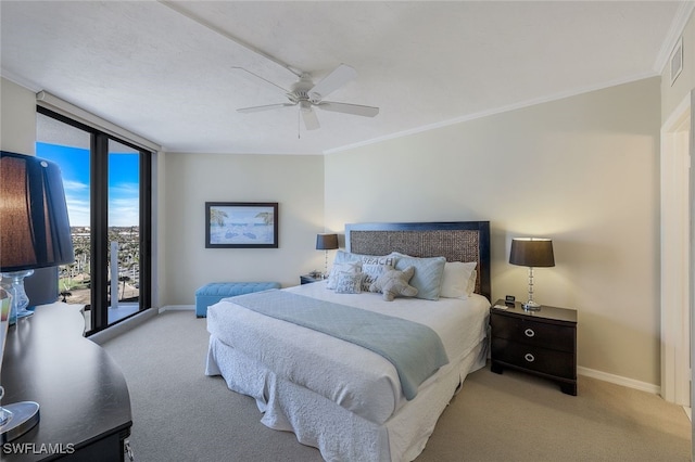 carpeted bedroom featuring ceiling fan, a wall of windows, crown molding, and access to outside