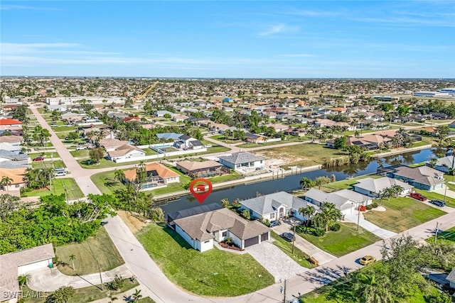 bird's eye view featuring a water view and a residential view