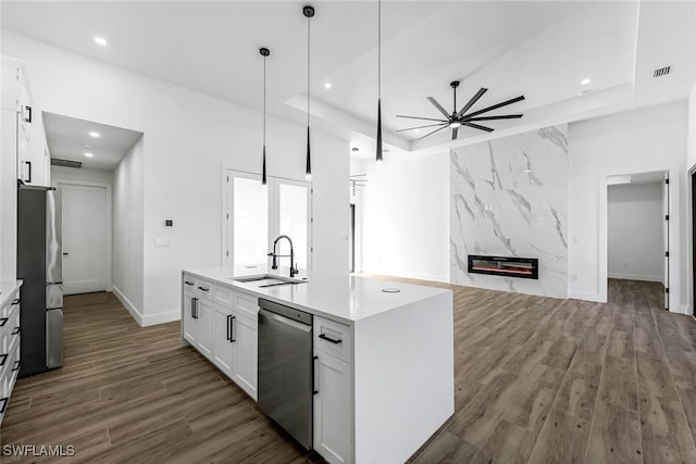 kitchen with white cabinetry, sink, an island with sink, and appliances with stainless steel finishes