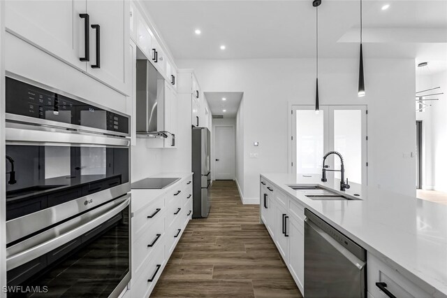 kitchen with sink, white cabinets, and stainless steel appliances