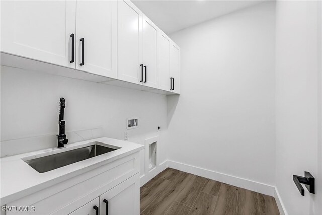 washroom featuring sink, washer hookup, cabinets, electric dryer hookup, and wood-type flooring