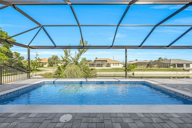 view of swimming pool with a patio and a lanai