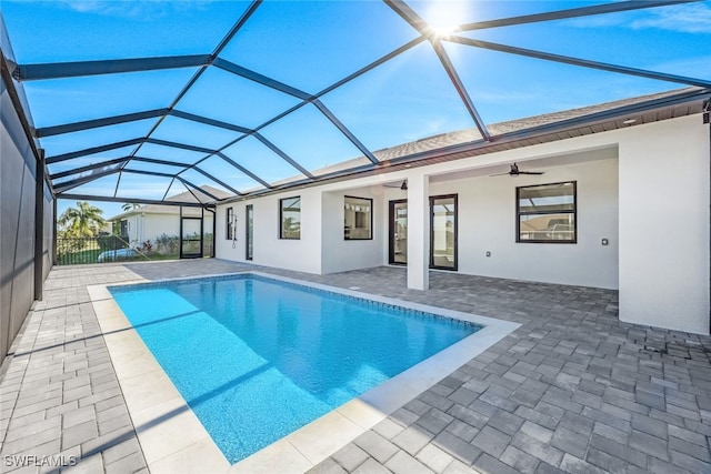 view of pool with a patio area, ceiling fan, and a lanai