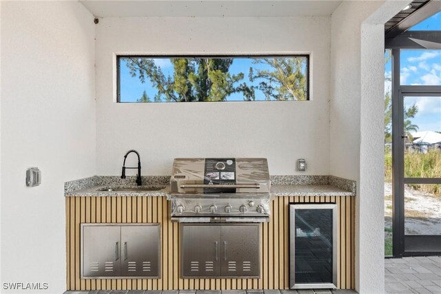 interior space featuring wine cooler and a sink