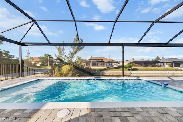 pool with a patio area, a lanai, and a residential view