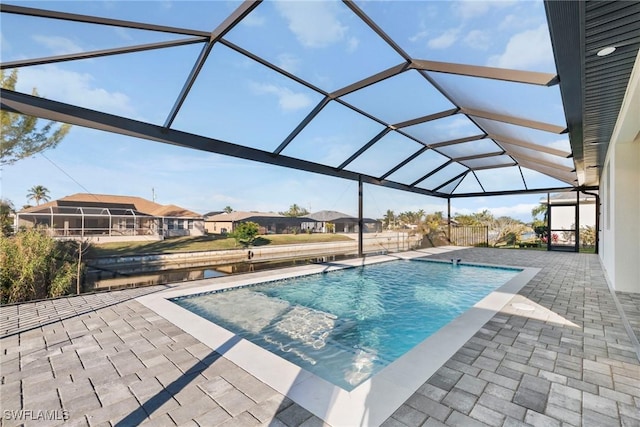 pool featuring a patio area, a lanai, and a residential view