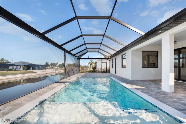 outdoor pool featuring a lanai, a patio area, and a water view