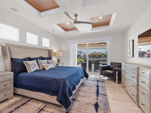 bedroom featuring a tray ceiling, access to exterior, and ceiling fan