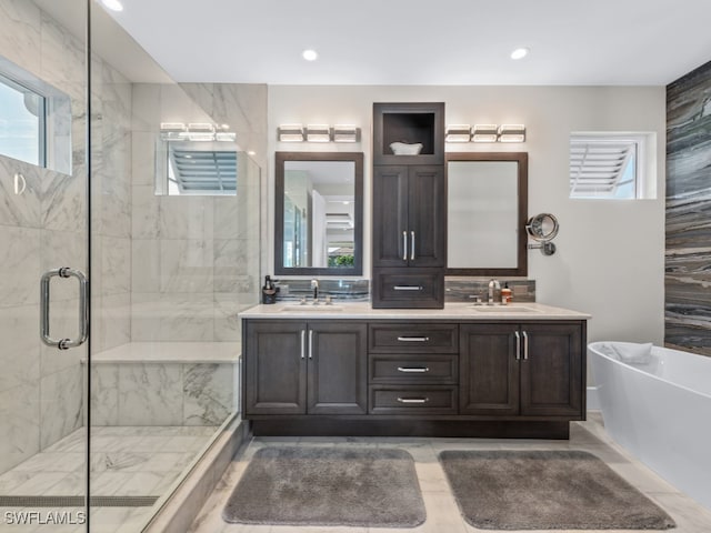 bathroom featuring vanity and shower with separate bathtub