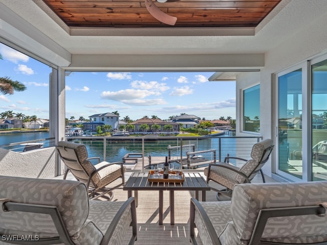 view of patio featuring a balcony and a water view