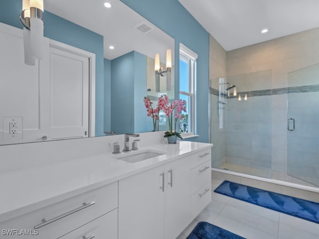 bathroom with tile patterned floors, vanity, and a shower with shower door