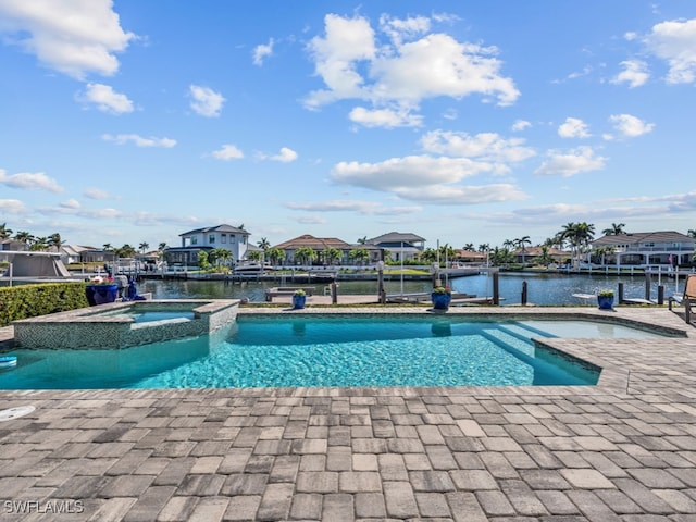 view of pool with an in ground hot tub, a boat dock, and a water view