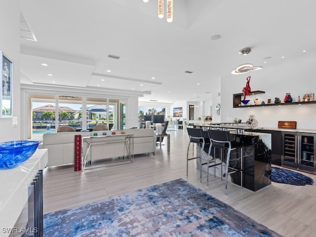 bar featuring white cabinetry, wine cooler, and light hardwood / wood-style flooring