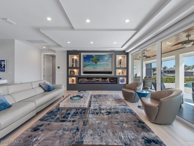 living room with hardwood / wood-style floors and ceiling fan