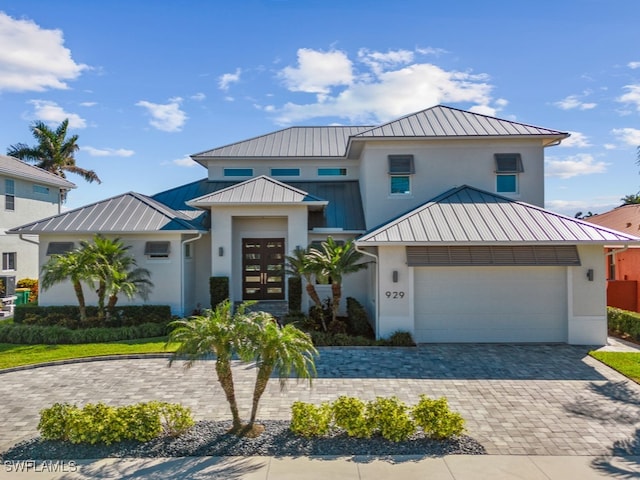 view of front of property featuring a garage and french doors