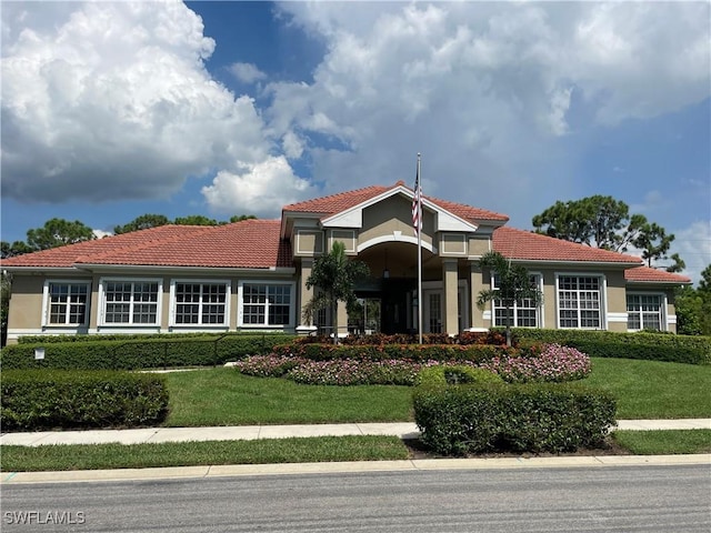 mediterranean / spanish-style home featuring a front yard