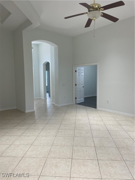 spare room featuring ceiling fan and light tile patterned floors