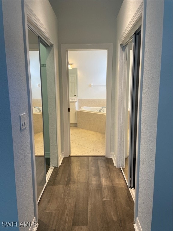 hallway with dark hardwood / wood-style floors