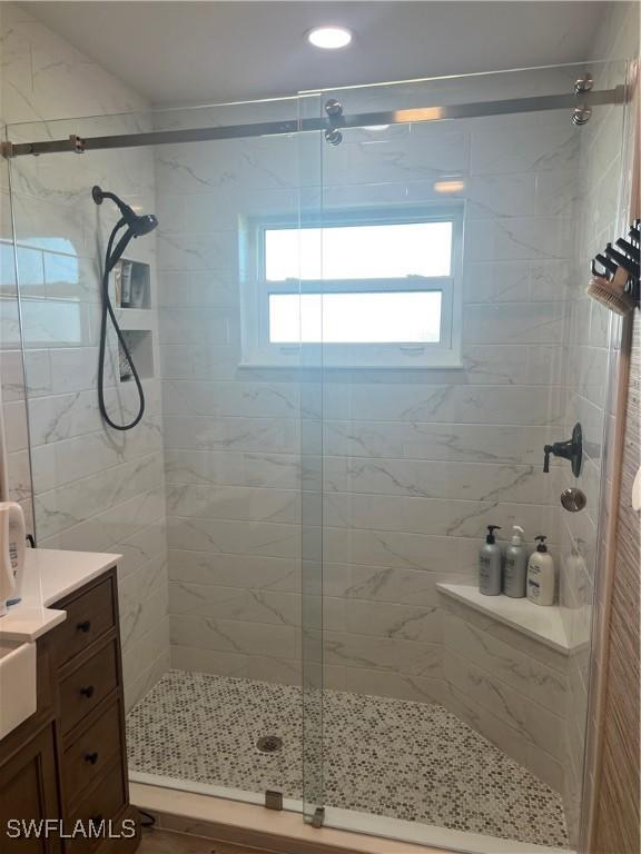 bathroom featuring vanity and an enclosed shower