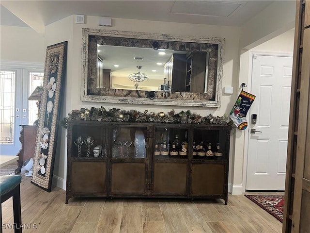 bar with light wood-type flooring