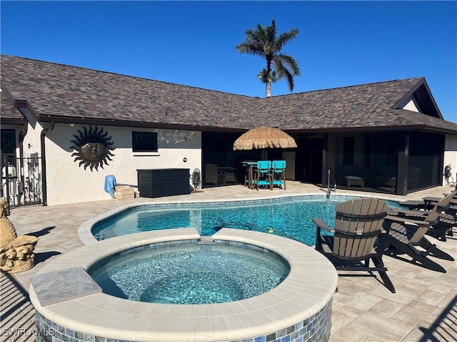 view of swimming pool featuring an in ground hot tub and a patio