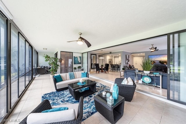 tiled living room featuring a textured ceiling, floor to ceiling windows, and ceiling fan