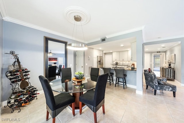 dining space featuring crown molding, light tile patterned floors, and ceiling fan