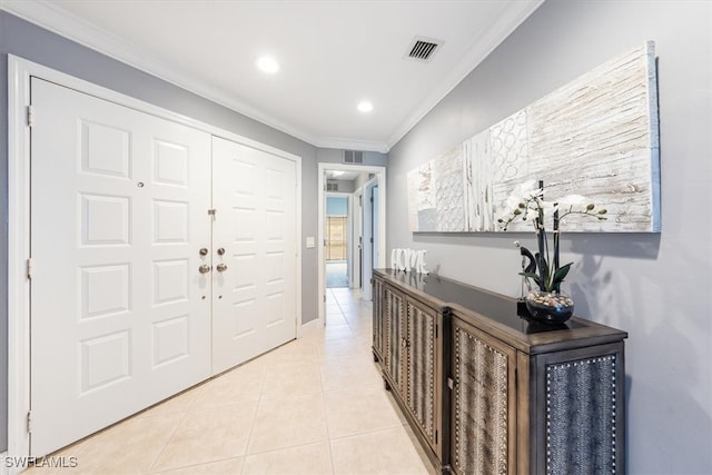 foyer featuring light tile patterned floors and ornamental molding