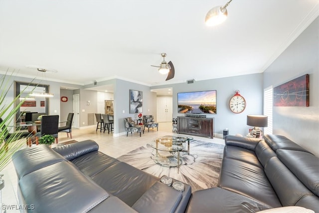 tiled living room with ceiling fan and crown molding