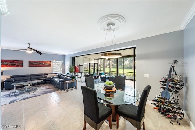 dining room featuring ceiling fan, ornamental molding, and light tile patterned flooring