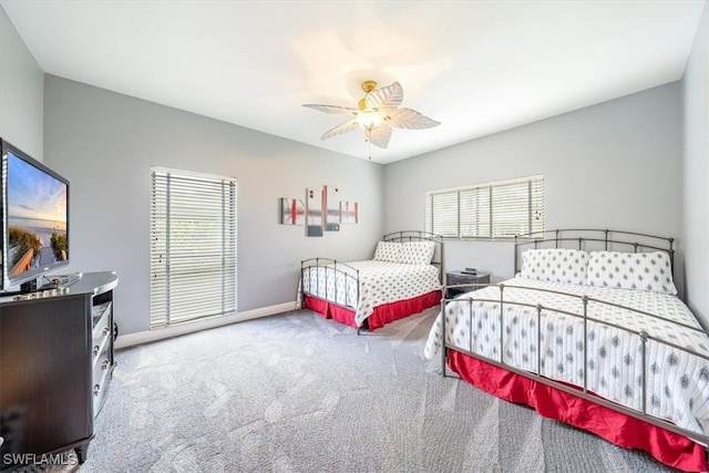 bedroom with ceiling fan and light colored carpet